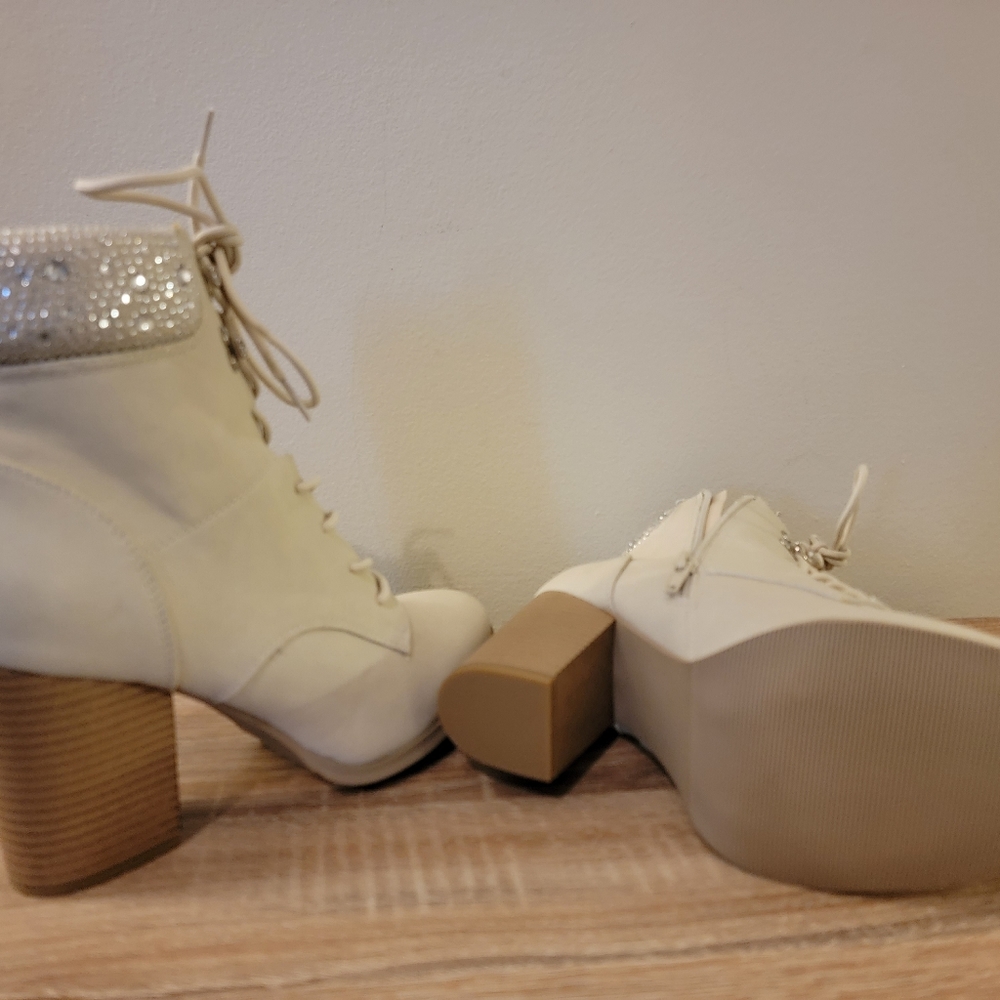 XOXO Boots with a high heel. The color of the shoes are beige with a brown heel.